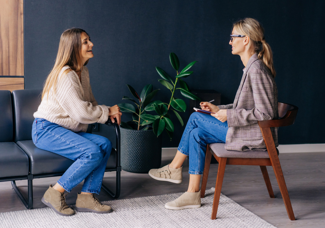 Psychologist Talking with a Joyful Female Patient Indoors